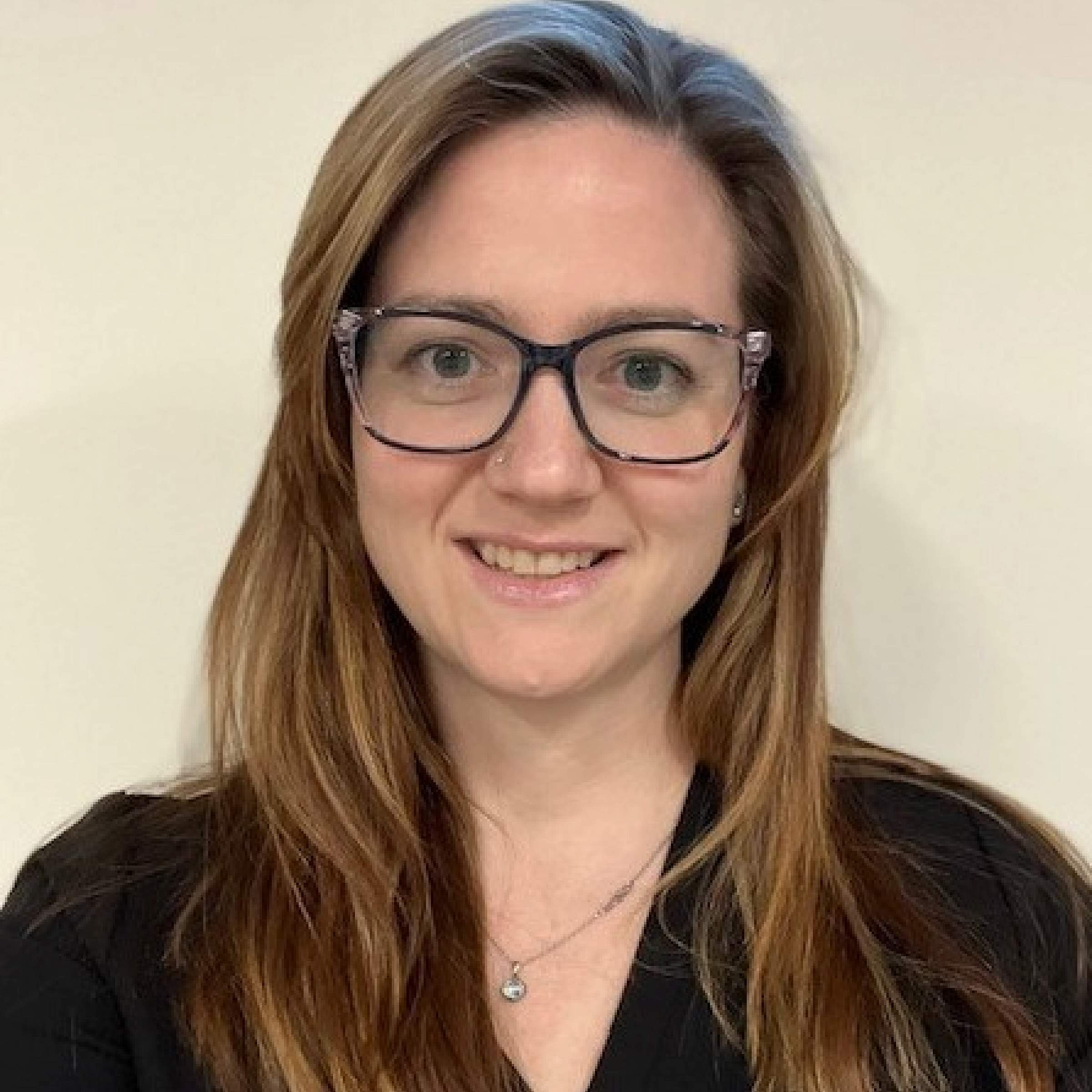 Headshot, Astrid Littlewood, long brown hair with glasses
